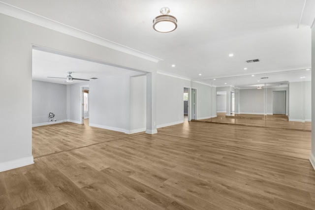 unfurnished living room featuring crown molding, wood-type flooring, and ceiling fan