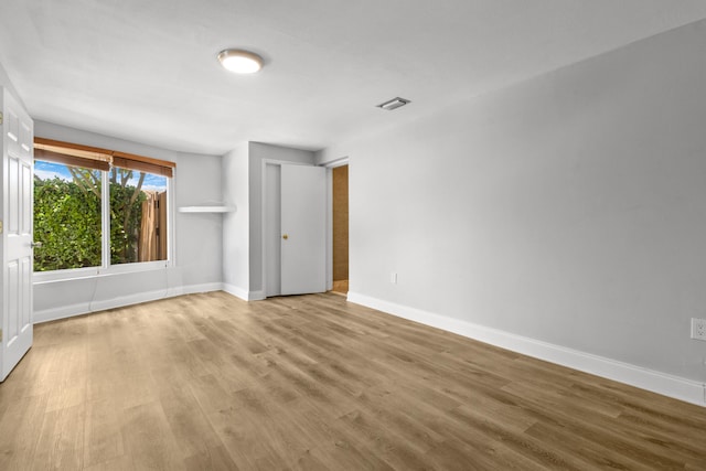 spare room featuring light hardwood / wood-style flooring