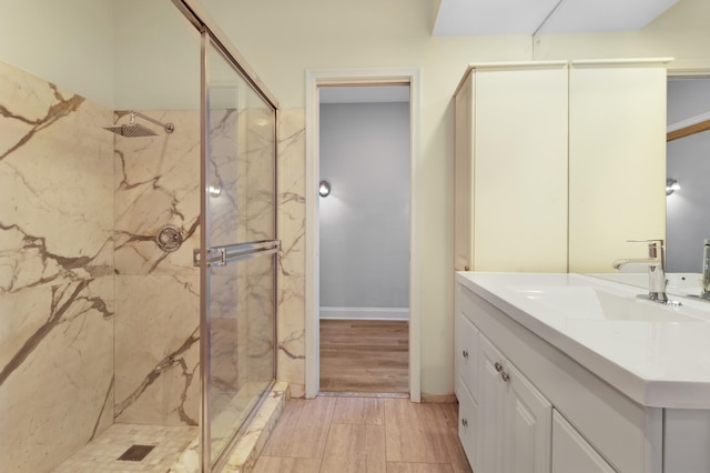 bathroom with vanity, walk in shower, and hardwood / wood-style floors