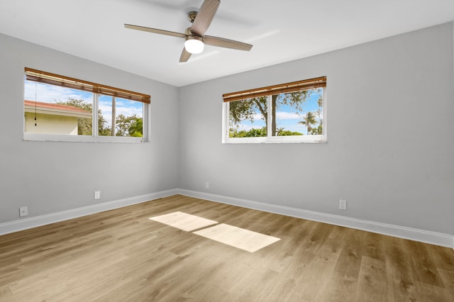 spare room featuring light hardwood / wood-style flooring, plenty of natural light, and ceiling fan