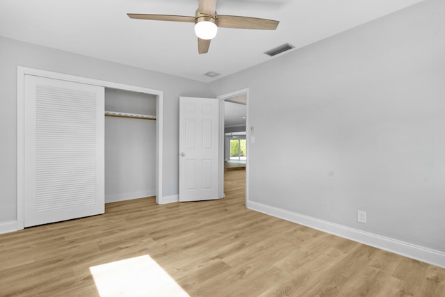 unfurnished bedroom with a closet, light hardwood / wood-style floors, and ceiling fan