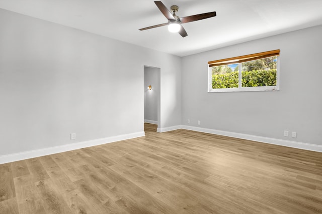 empty room with ceiling fan and light wood-type flooring