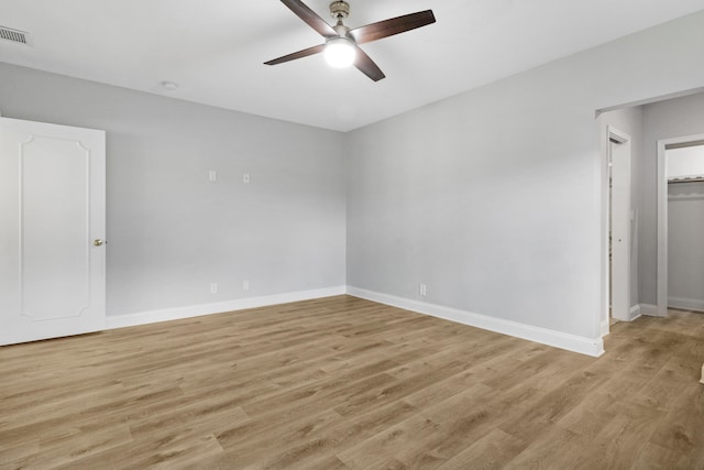 empty room with light hardwood / wood-style floors and ceiling fan