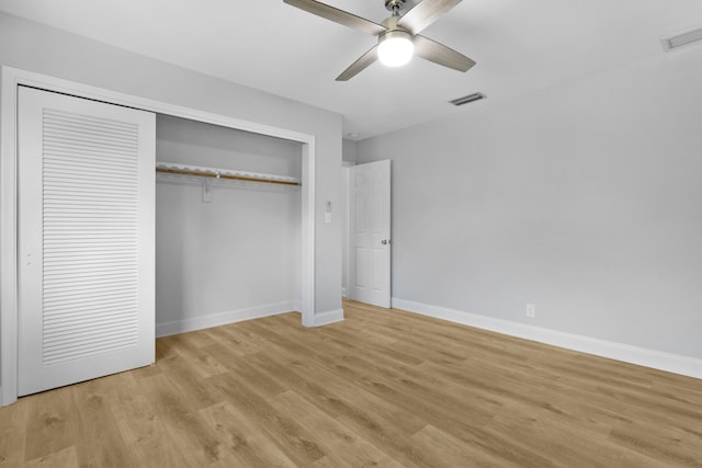 unfurnished bedroom featuring light hardwood / wood-style floors, a closet, and ceiling fan