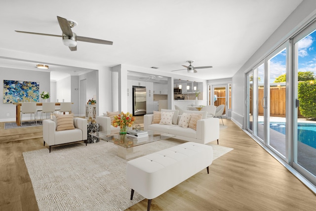 living room featuring light hardwood / wood-style floors and ceiling fan