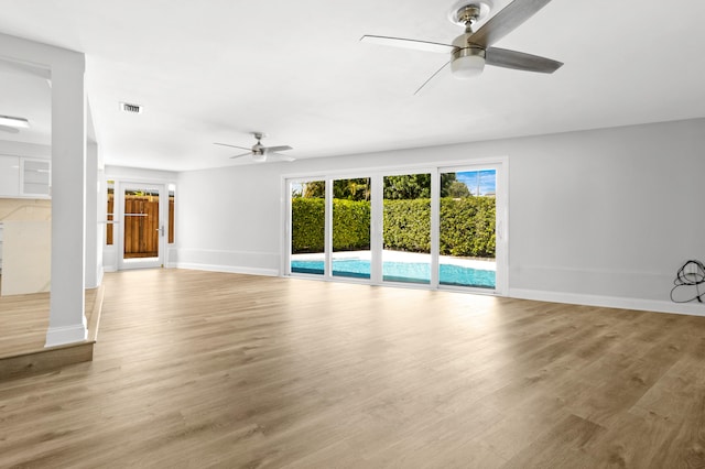 unfurnished living room featuring light hardwood / wood-style floors and ceiling fan