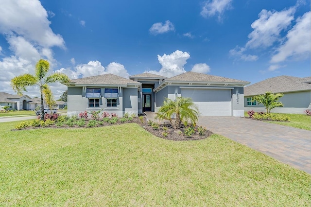 view of front of home featuring a garage and a front yard