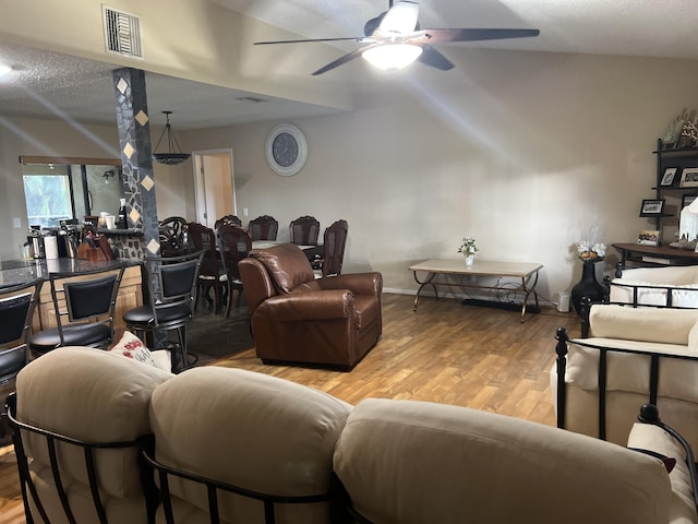 living room featuring light hardwood / wood-style flooring, ceiling fan, and lofted ceiling