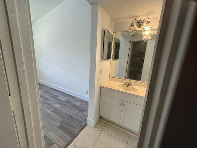 bathroom featuring tile patterned flooring, baseboards, and vanity