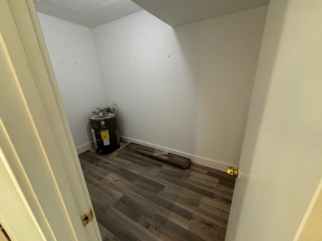 interior space with baseboards and dark wood-style flooring