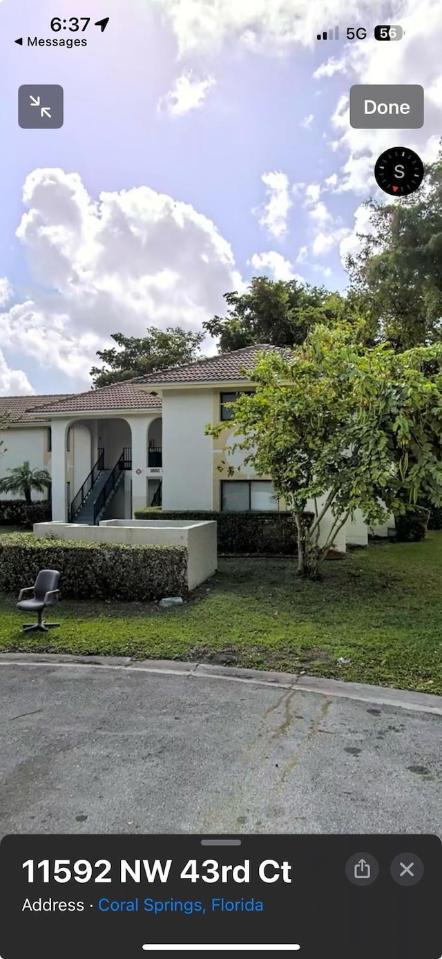 mediterranean / spanish-style home with a front lawn