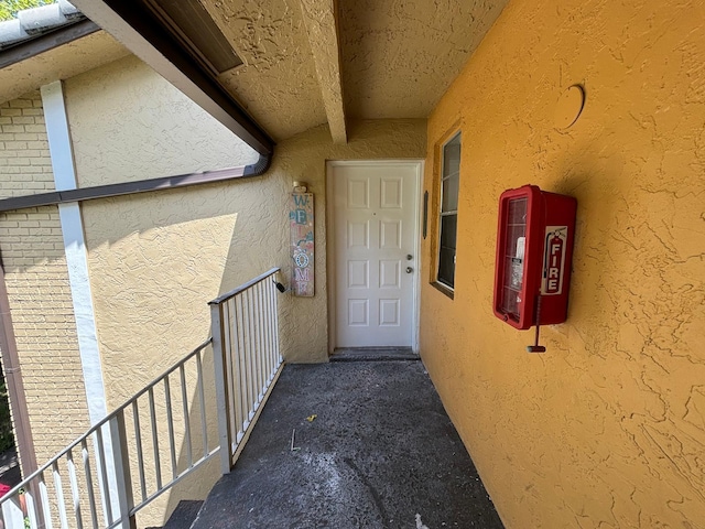 entrance to property featuring stucco siding