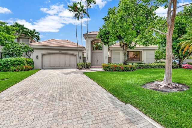 view of front of house featuring a garage and a front lawn