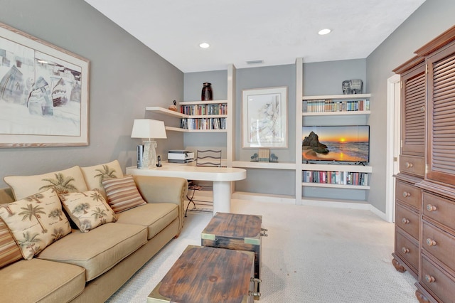 carpeted living room with built in shelves