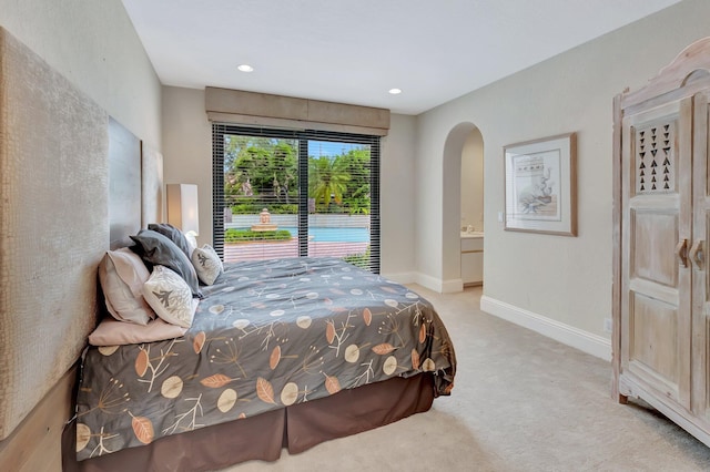 carpeted bedroom featuring ensuite bathroom