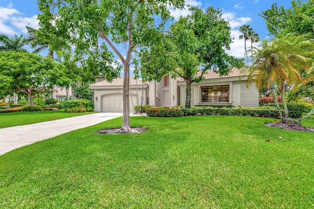 view of front of house featuring a garage and a front lawn