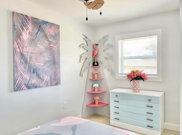 bedroom with ceiling fan and light tile patterned floors