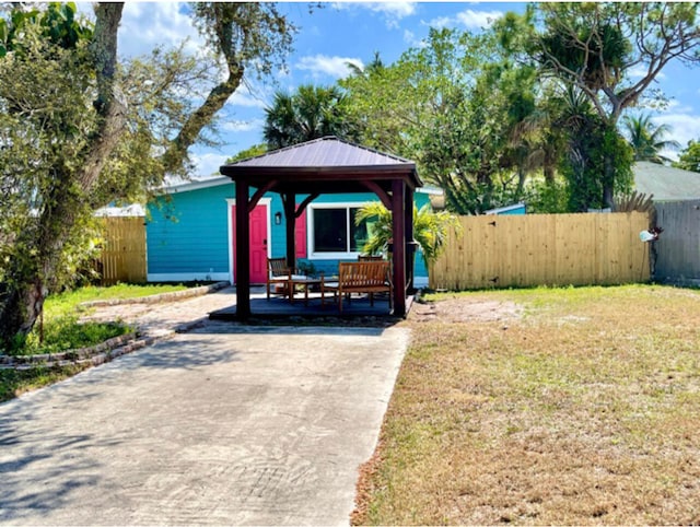 view of front facade with a gazebo and a front yard