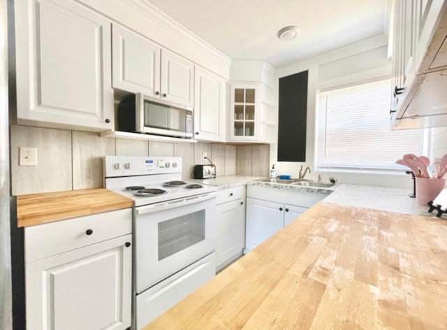 kitchen featuring decorative backsplash, electric range, wood counters, white cabinetry, and sink