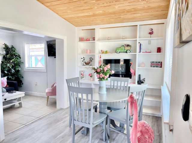 dining space featuring light hardwood / wood-style flooring, built in features, and wooden ceiling