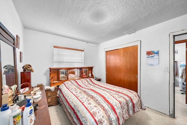 bedroom with a closet and a textured ceiling