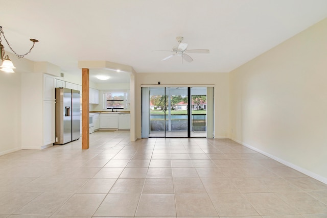 tiled spare room with ceiling fan