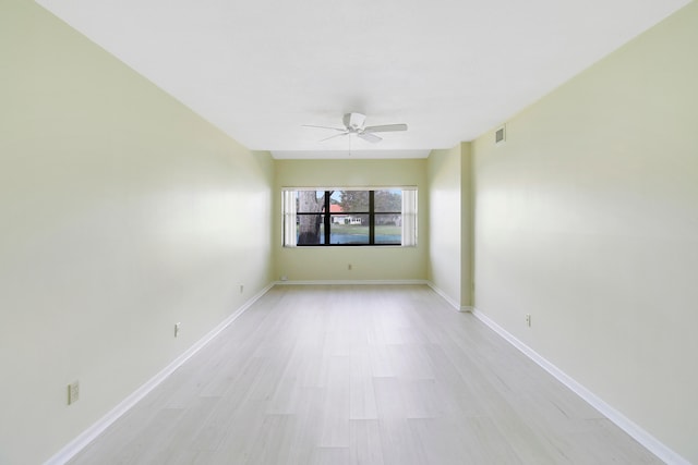 spare room with light hardwood / wood-style flooring and ceiling fan