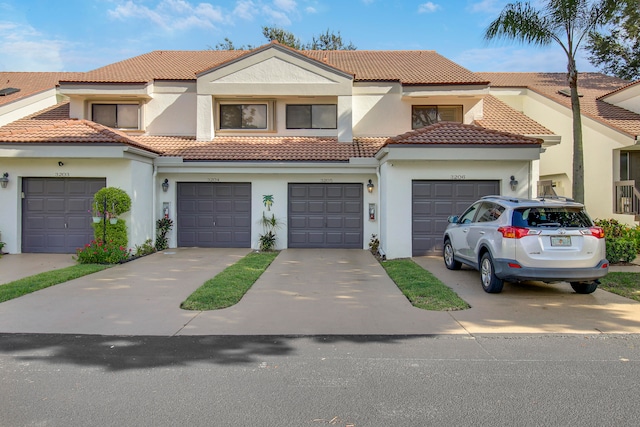 mediterranean / spanish-style house with a garage