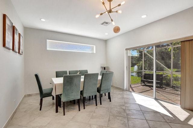 dining room with light tile patterned floors, a wealth of natural light, and a notable chandelier