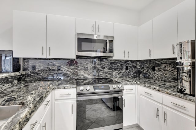 kitchen featuring white cabinetry, appliances with stainless steel finishes, and decorative backsplash