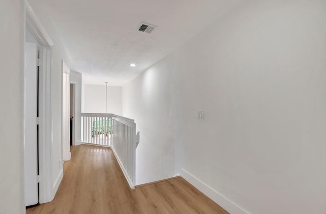 hallway with light hardwood / wood-style flooring