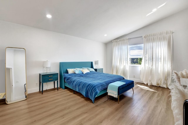 bedroom featuring light wood-type flooring, vaulted ceiling, baseboards, and recessed lighting