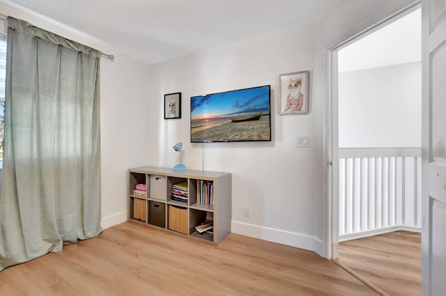 interior space with baseboards and wood finished floors