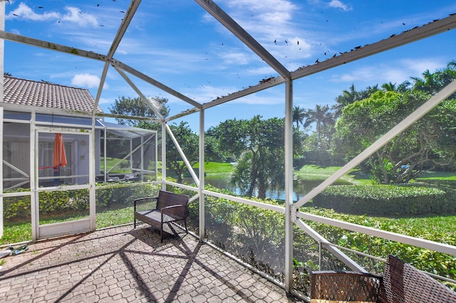 unfurnished sunroom featuring a water view