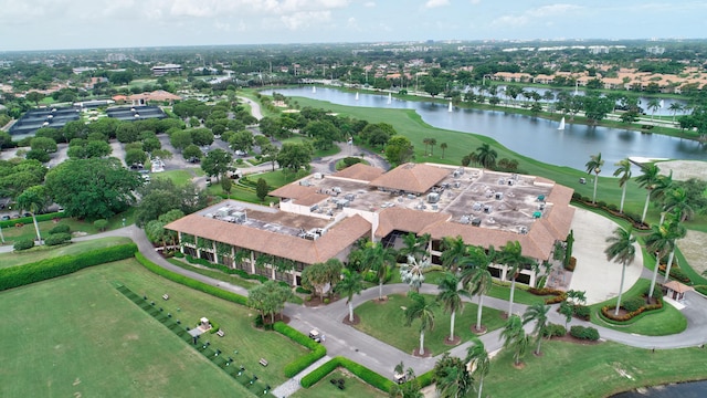 birds eye view of property featuring view of golf course and a water view