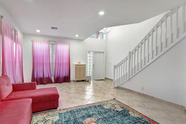 living area featuring stairs, visible vents, a notable chandelier, and recessed lighting