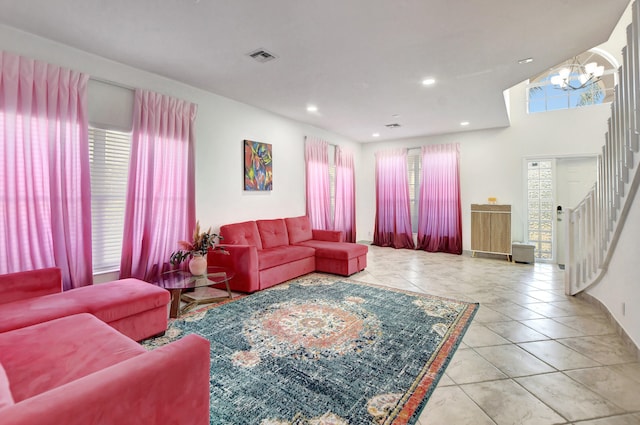 tiled living room featuring an inviting chandelier and a healthy amount of sunlight