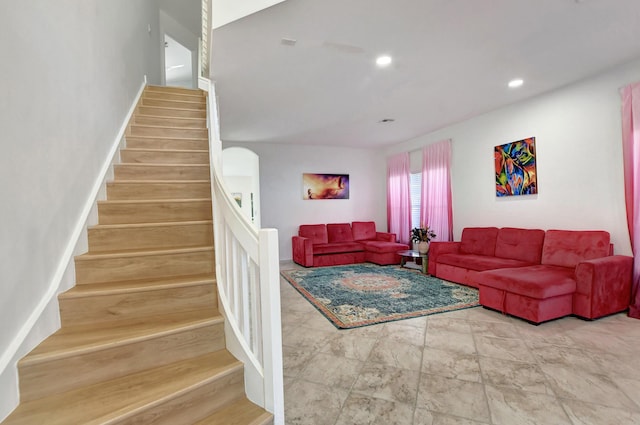 living area featuring stairs, baseboards, and recessed lighting