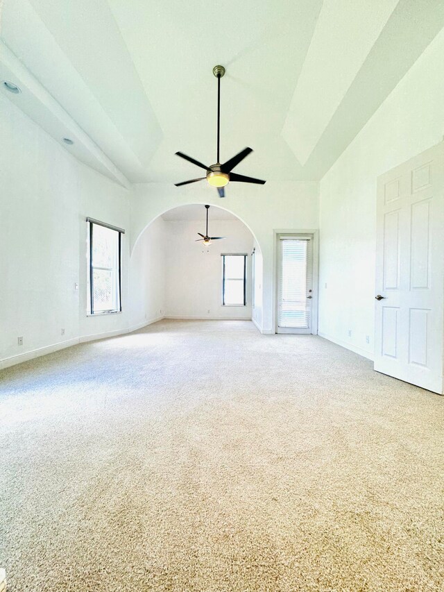 interior space with carpet, ceiling fan, and vaulted ceiling