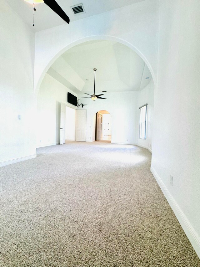 unfurnished living room with carpet flooring and vaulted ceiling