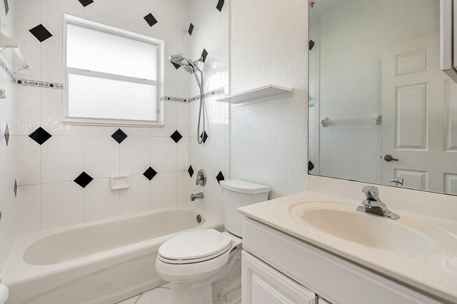 full bathroom featuring vanity, toilet, and tiled shower / bath combo