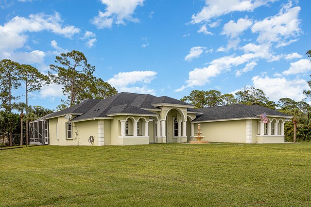 view of front facade featuring a front yard and a lanai