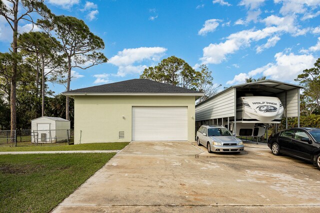 view of home's exterior featuring a garage, a yard, a carport, and a shed