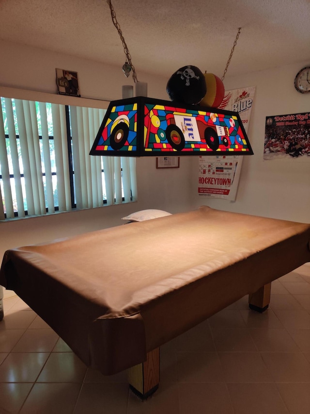 playroom with pool table, a textured ceiling, and tile patterned floors