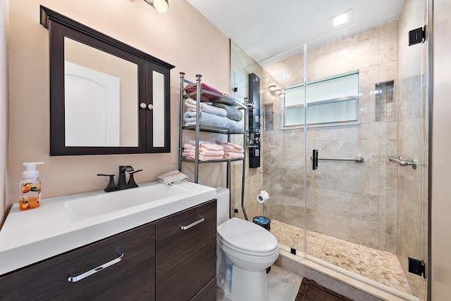 bathroom with a shower with shower door, toilet, tile patterned flooring, and vanity