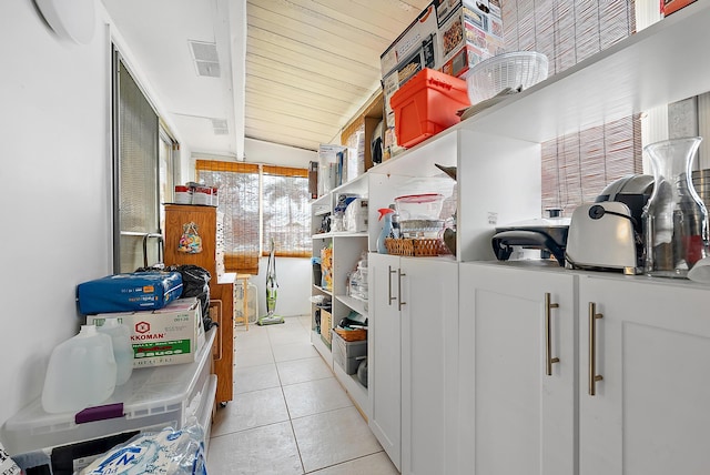 kitchen featuring white cabinetry and light tile patterned flooring