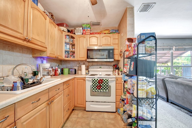 kitchen with ceiling fan, decorative backsplash, electric stove, and light tile patterned flooring