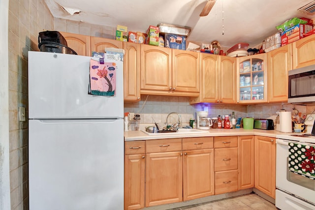 kitchen with sink, light tile patterned floors, white appliances, tasteful backsplash, and ceiling fan