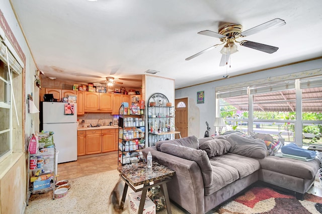 tiled living room featuring ceiling fan and sink