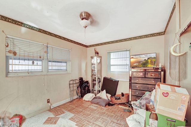 interior space with ceiling fan, crown molding, and light parquet flooring